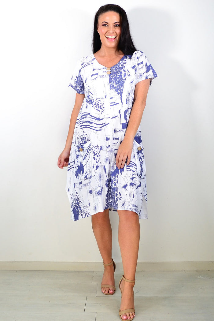 Ruby Rain Sail Away short sleeves tunic dress hanging on a rack with a colorful, nautical-inspired pattern and relaxed fit.
