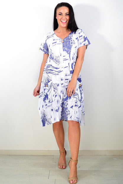 Ruby Rain Sail Away short sleeves tunic dress hanging on a rack with a colorful, nautical-inspired pattern and relaxed fit.
