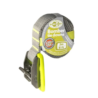Sea To Summit 2 metre lime coloured Bomber Tie Down Strap coiled showing the silcone protection pad on a white background