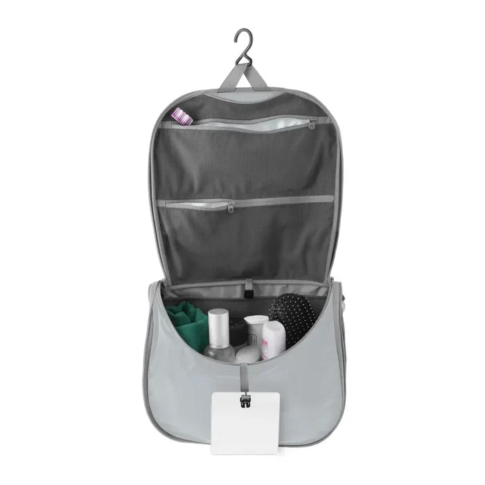 Sea To Summit Hanging Toiletry Bag Large in grey with the lid open to show the hanging  bar on a white background