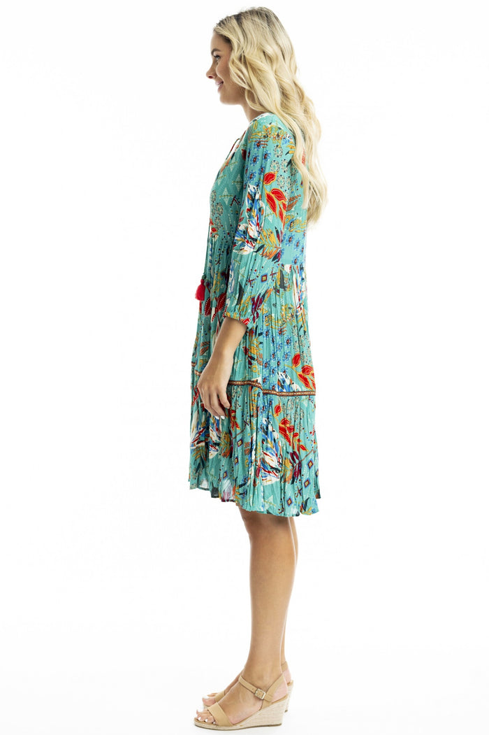 Orientique Serengetti V-neckline trim tunic dress displayed on a hanger, showcasing the stylish neckline and relaxed fit.