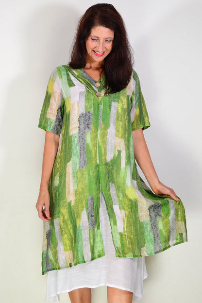 Green summer tunic dress by La Mode with floral patterns, lightweight fabric, and a relaxed fit, displayed on a hanger.
