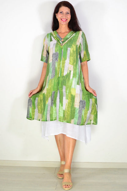 Green summer tunic dress by La Mode, featuring a flowy fabric and stylish shades of green, displayed on a hanger.