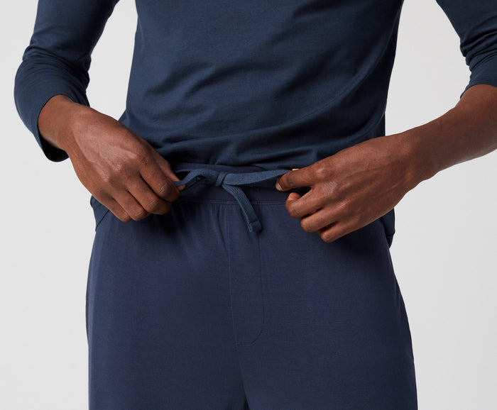 view of man tying drawstrings of Silver HD Pajama Pant in True Navy