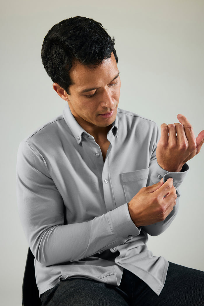 Image of a man adjusting the sleeve of Silver Pique Button Up in Monument