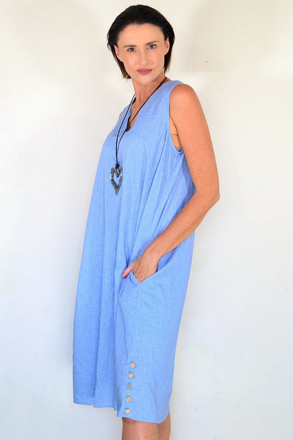 Light blue sleeveless tunic dress from Willow Tree, flowing fabric and simple design, hanging on a hanger.