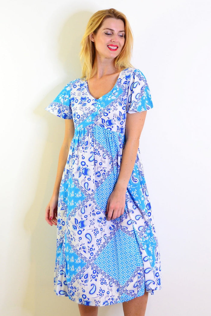 Soft blue floral paisley tunic dress by Hourglass, featuring a flowy silhouette and intricate floral patterns.