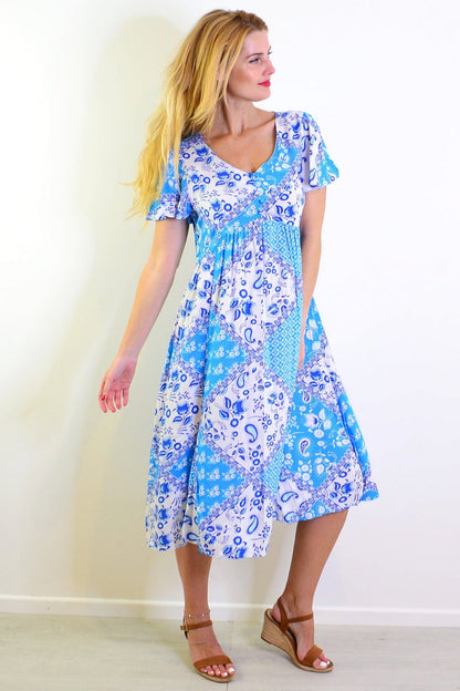 Soft blue floral paisley tunic dress by Hourglass, featuring a relaxed fit, long sleeves, and a vibrant, detailed floral pattern.