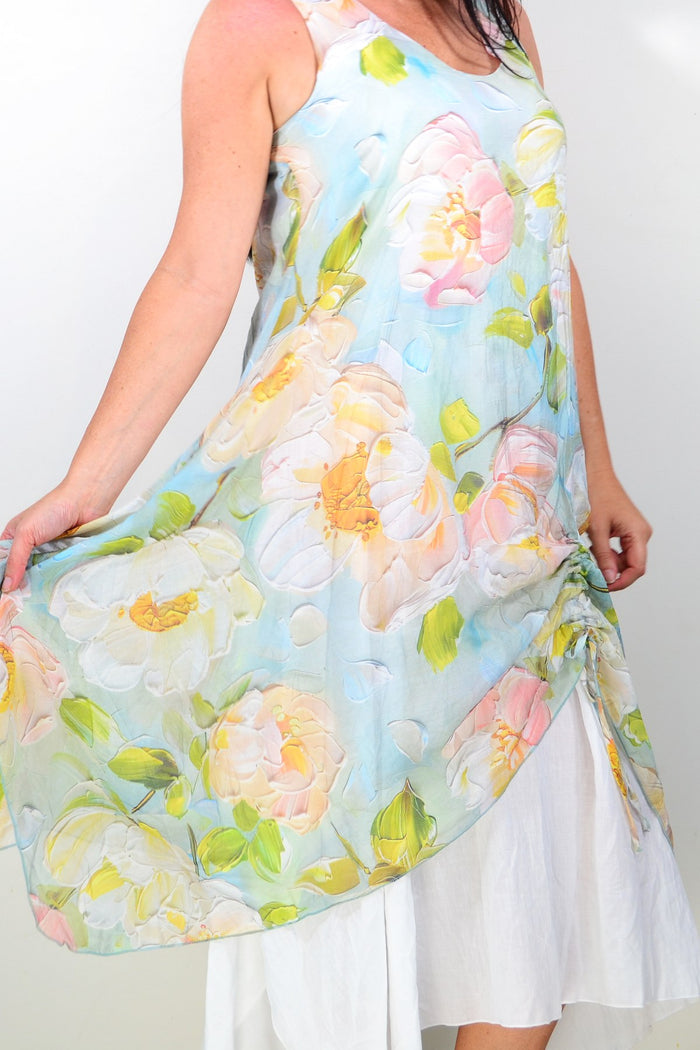Soft blue and pink floral sleeveless tunic dress by Cali&Co, featuring a relaxed fit and feminine floral pattern.