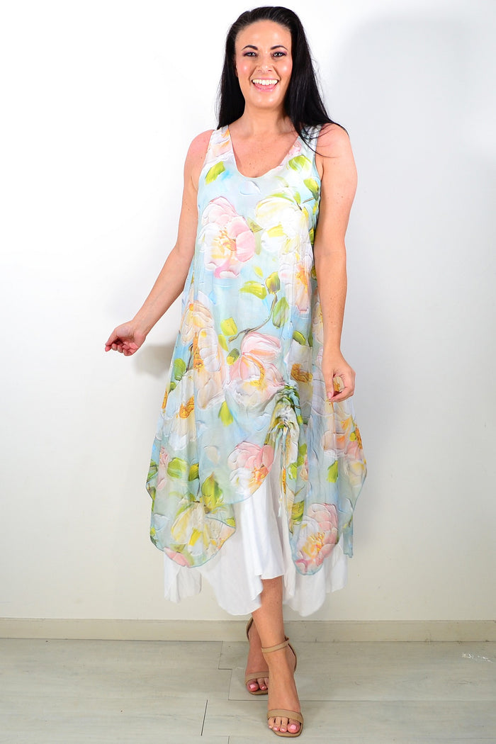 Soft blue and pink floral sleeveless tunic dress by Cali&Co with a relaxed fit, displayed on a hanger against a neutral background.