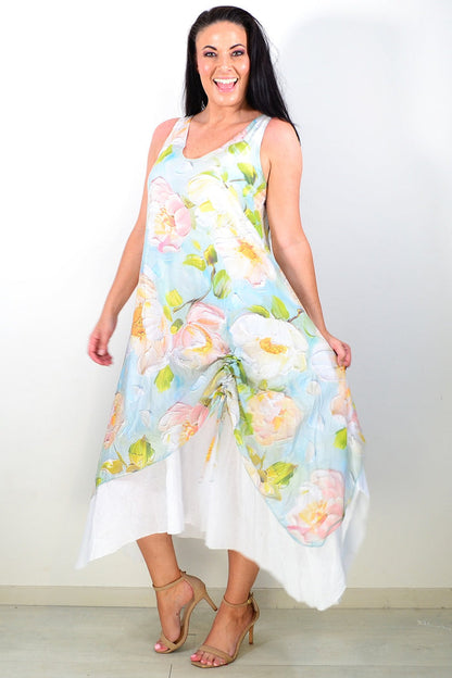 Soft blue and pink floral sleeveless tunic dress by Cali&Co displayed on a hanger with a flowing fabric design.