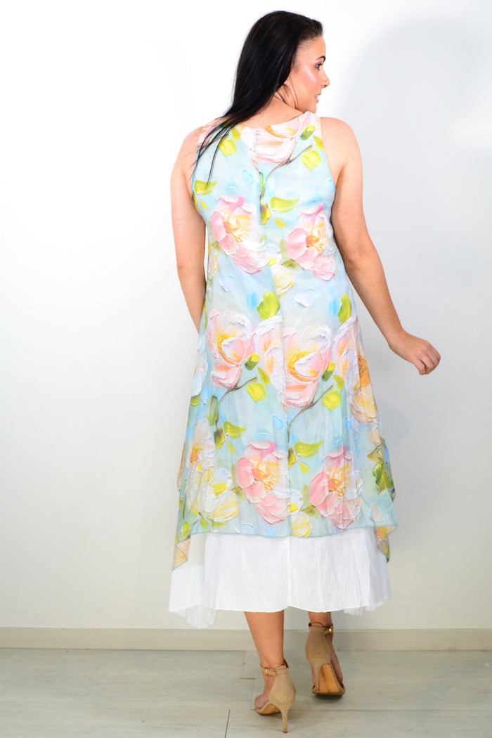Soft blue and pink floral sleeveless tunic dress by Cali&Co, with a relaxed fit and lightweight fabric, displayed on a hanger.