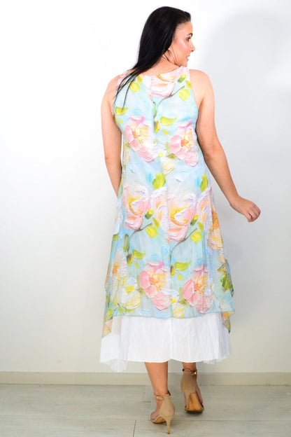 Soft blue and pink floral sleeveless tunic dress by Cali&Co, with a relaxed fit and lightweight fabric, displayed on a hanger.