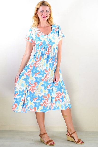 Hourglass soft garden floral tunic dress with long sleeves and a relaxed fit, featuring a colorful garden floral pattern.