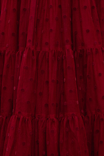Close-up of a red dress with black polka dots