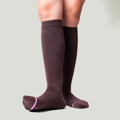 Knee-high compression socks in a solid dark brown color with a ribbed texture and pink accents at the toe.