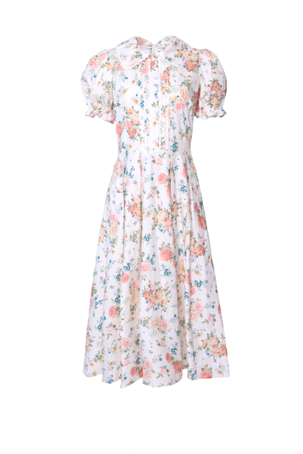 The Sophia Dress in Countryside Peony Blossom by Ivy City Co is an ivory cotton floral midi with a vibrant pattern, short puffed sleeves, fitted waist, and a soft, flowing skirt for vintage-inspired elegance.