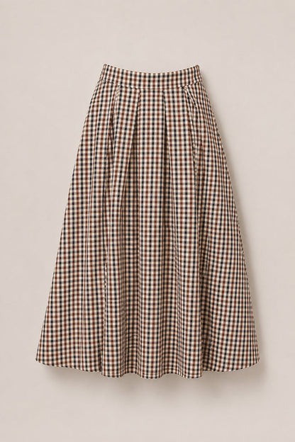 The Sophia Skirt in Chestnut Gingham by Ivy City Co is a mid-length, high-waisted skirt with a flared silhouette, featuring a checkered gingham pattern in shades of brown, beige, and black. Crafted from soft cotton fabric, this stylish skirt is showcased against a light background.