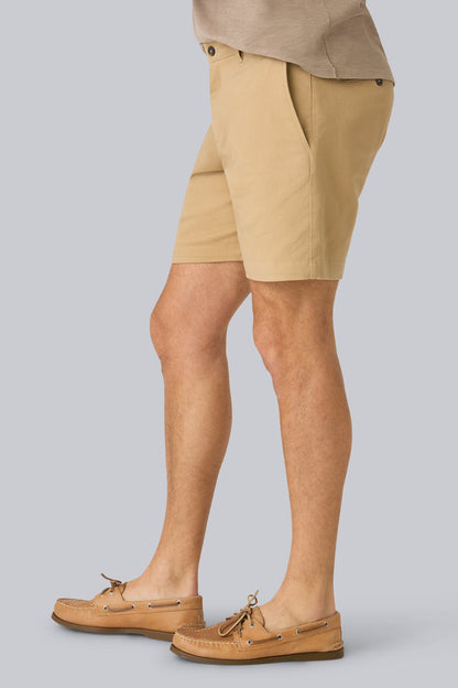 Side view of a man wearing Stretch Twill Chino Shorts 7" in Sisal
