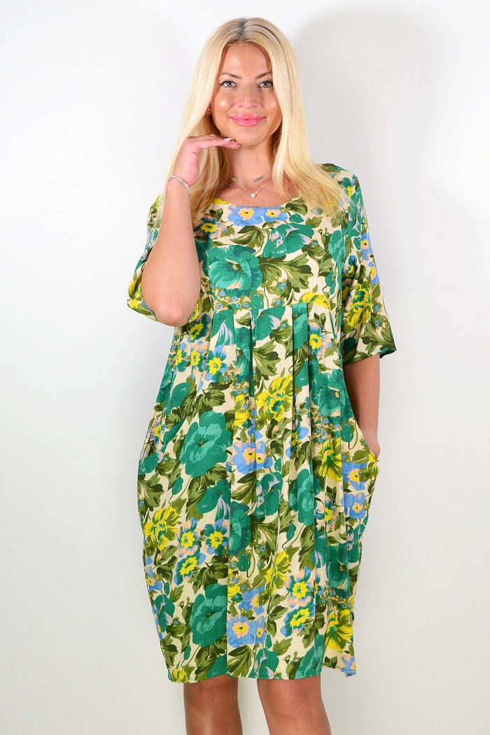 Hourglass Summer Green Delight Tunic Dress displayed on a hanger, featuring a vibrant green fabric and flowing, casual design.