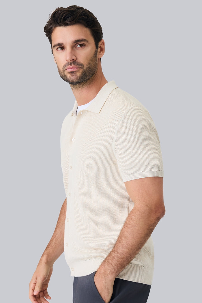 Side view of a man wearing Tech Linen Button Up Sweater Polo in Latte Heather