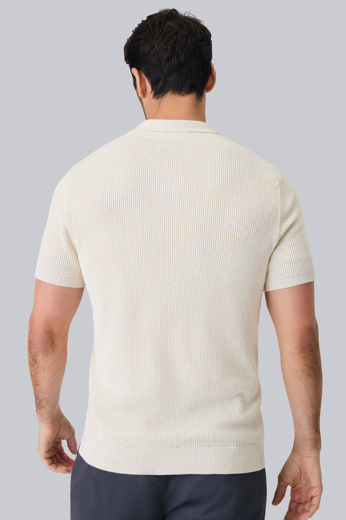 Back view of a man wearing Tech Linen Button Up Sweater Polo in Latte Heather