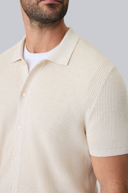 Detailed front view of a man wearing Tech Linen Button Up Sweater Polo in Latte Heather
