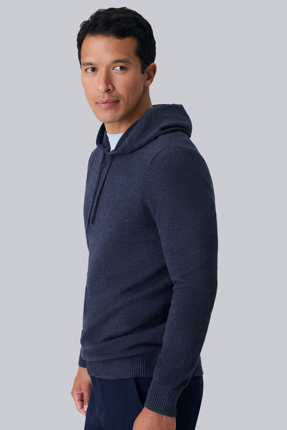 Side view of a man wearing Tech Linen Long Sleeve Hoodie in Navy Heather
