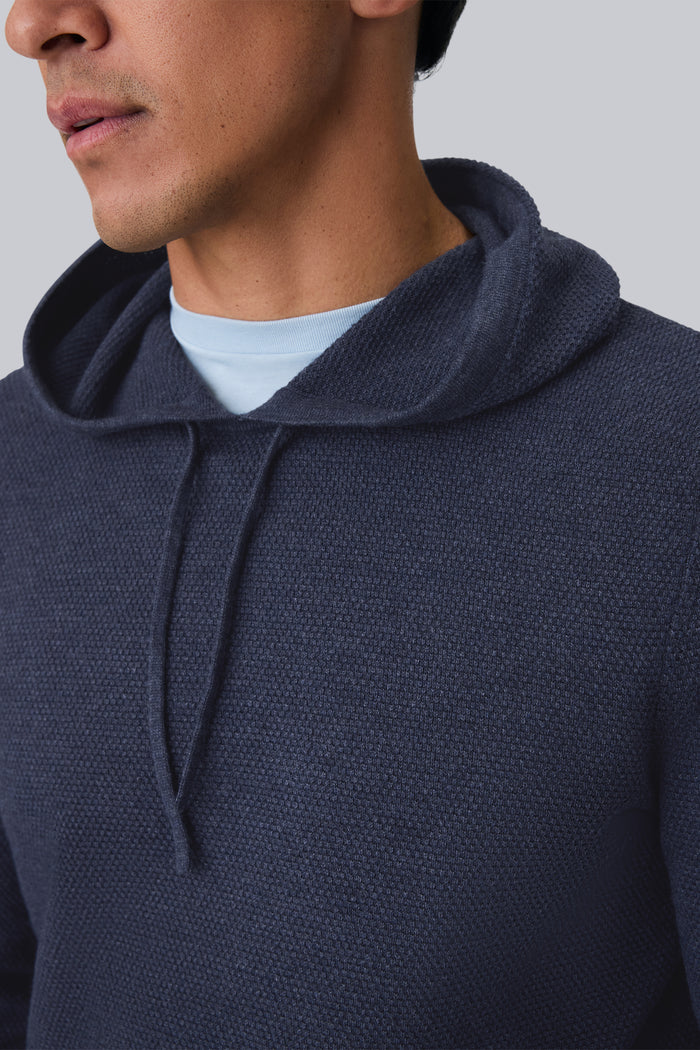 Detailed front view of a man wearing Tech Linen Long Sleeve Hoodie in Navy Heather