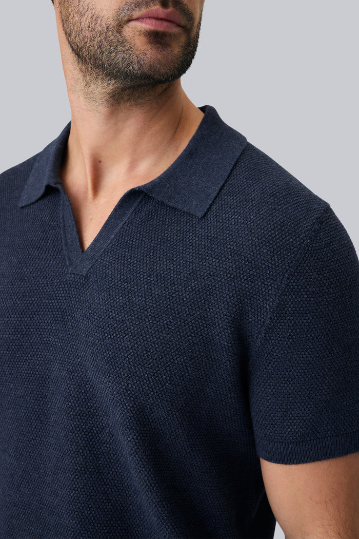 Detailed front view of a man wearing Tech Linen Johnny Collar Sweater Polo in Navy Heather
