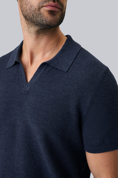 Detailed front view of a man wearing Tech Linen Johnny Collar Sweater Polo in Navy Heather