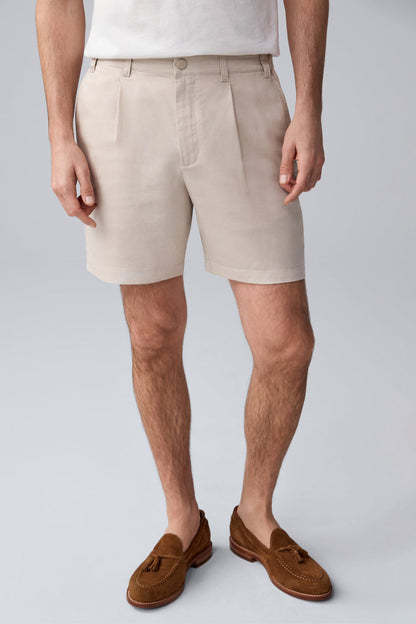 Front view of a man wearing Tech Linen  Pleated Short in Natural Linen