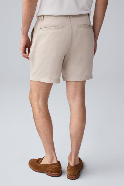 Back view of a man wearing Tech Linen  Pleated Short in Natural Linen
