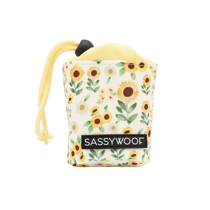 The Sassy Woof Treat Pouch - Sunflower Dreams is a small, yellow drawstring pouch with a sunflower pattern—ideal for pet owners to carry treats during dog training sessions.