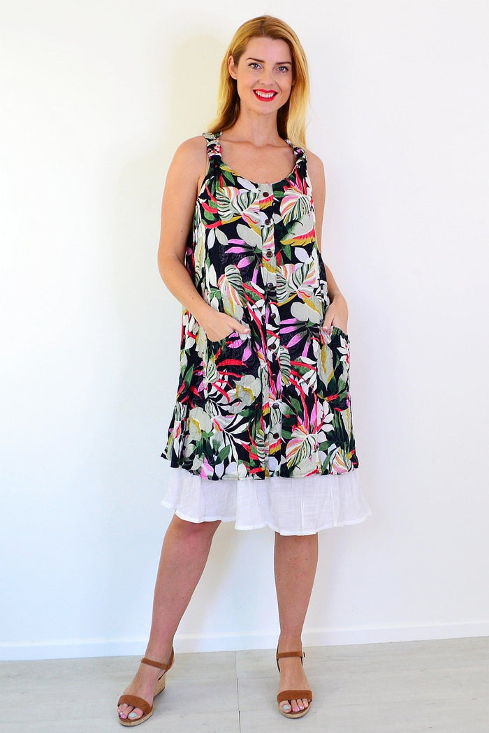 Missy Q tropical forest leaf crinkle tunic dress hanging on a hanger with lush green leaf pattern and lightweight fabric.