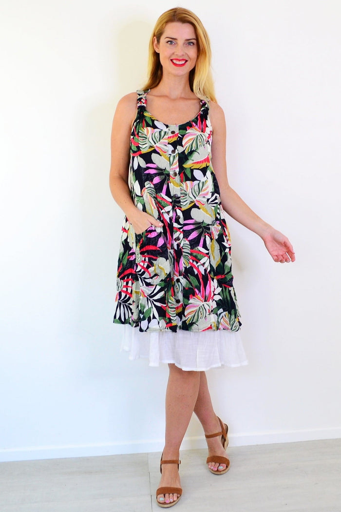 Missy Q Tropical Forest Leaf Crinkle Tunic Dress hanging on a hanger, featuring a vibrant leafy print and lightweight fabric.