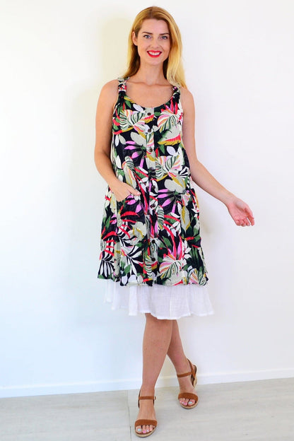 Missy Q Tropical Forest Leaf Crinkle Tunic Dress hanging on a hanger, featuring a vibrant leafy print and lightweight fabric.