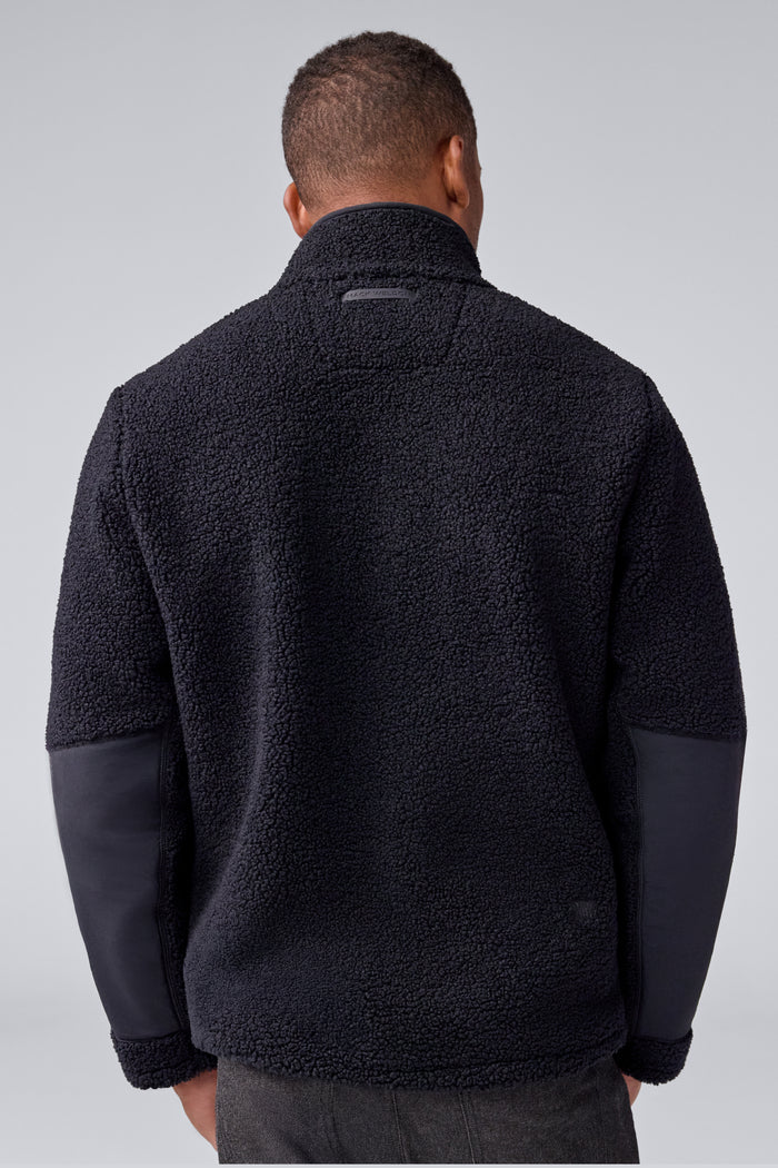 Back view of a man wearing WARMKNIT Sherpa Fleece in True Black