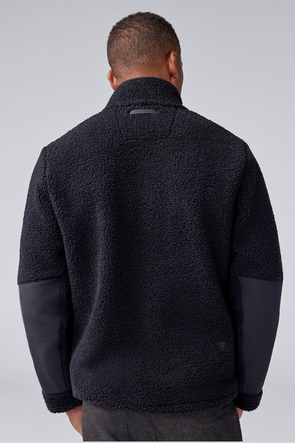 Back view of a man wearing WARMKNIT Sherpa Fleece in True Black