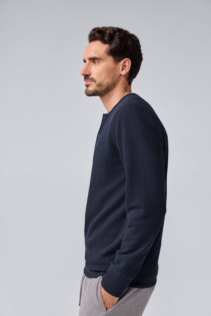 Side view of a man wearing Warmknit Waffle Long Sleeve Henley in Total Eclipse.