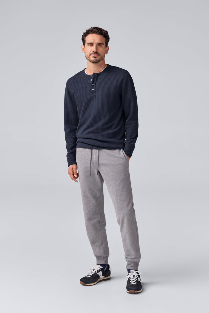 Full front view of a man wearing Warmknit Waffle Long Sleeve Henley in Total Eclipse.