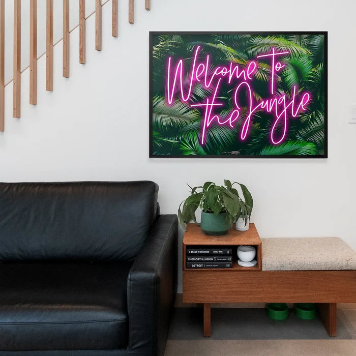 Welcome To The Jungle Tropical Neon Print, typography print framed above a living room sofa
