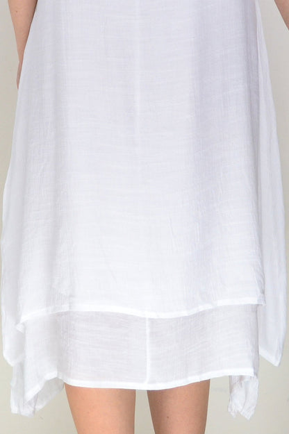 White summer tunic dress by La Mode, lightweight and flowy with short sleeves and a relaxed fit, displayed on a hanger.