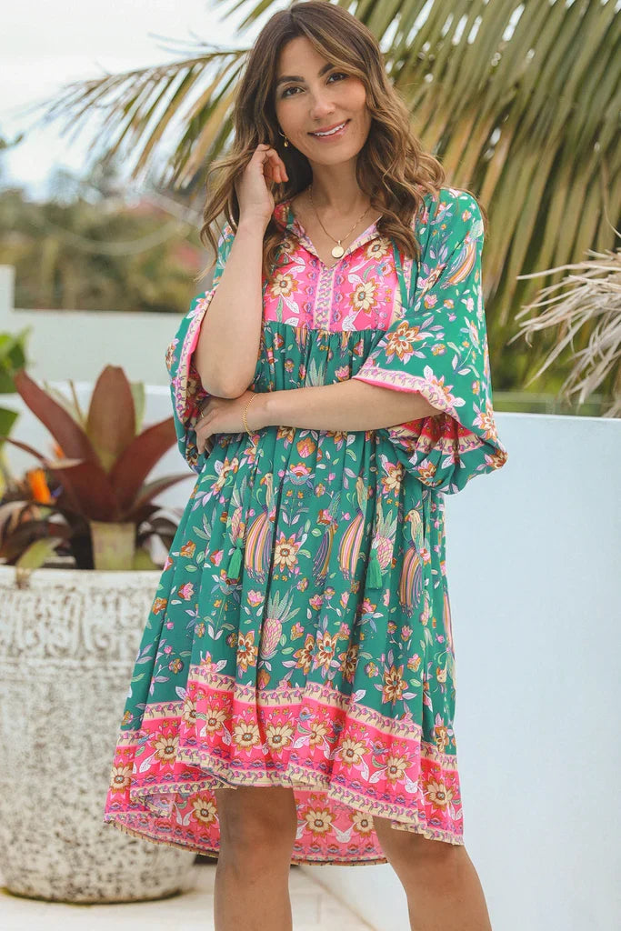 Dream Willow Bohemian Queen Dress tunic featuring flowing fabric and boho style, displayed on a hanger with intricate details.