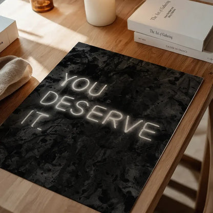 You Deserve It Neon Style Print, typography print unframed on a home office desk
